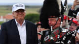 A bagpipe player wears traditional dress next to Donald Trump as he arrived at his Trump Turnberry Resort on June 24, 2016 in Ayr, Scotland.