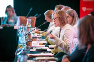 Person speaking at roundtable event.