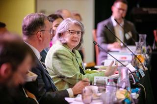 Person talking at a roundtable discussion