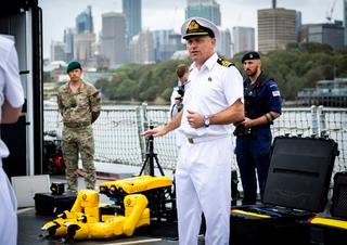 On board HMS Tamar, UK Royal Navy Commander Sean Heaton MBE shows senior AUKUS defence leaders the capabilities of a range of autonomous systems used during the Integrated Battle Problem 23.3 exercise at Fleet Base East, NSW.