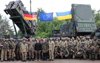 krainian President Volodymyr Zelensky and German Defence Minister Boris Pistorius stand with Ukrainian and German soldiers during a visit to a military training area in north-eastern Germany where Ukrainian soldiers are trained on the Patriot air defence missile system, June 2024.