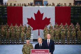 Canadian Prime Minister Mark Carney is flanked by Chief of the Defence Staff General Jennie Carignan and Minister of National Defence David McGuinty as they attend a tour of the Fort York Armoury in Toronto, June 2025.